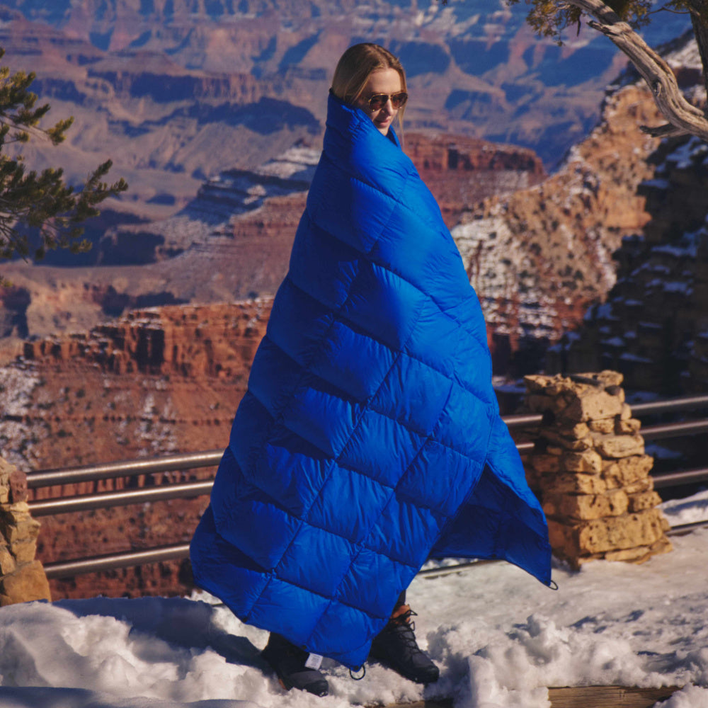 Photo of a woman wearing the down blanket at the Grand Canyon